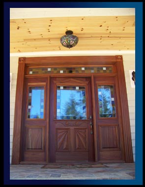 Custom Mahogany Entry Doors With Sunbursts Raised Panel Sidelites and a Full Transom