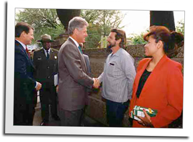 Mill founder Eric Hollenbeck shakes hands with President Bill Clinton